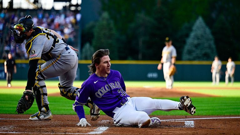 DENVER, COLORADO - JUNE 20: Jake McCarthy #31 of the Colorado Rockies slides to score after hitting a first inning inside-the-park home run against the Pittsburgh Pirates at Coors Field on June 20, 2026 in Denver, Colorado. (Photo by Dustin Bradford/Getty Images)