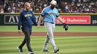PHOENIX, ARIZONA - JULY 04: Brandon Woodruff #53 of the Milwaukee Brewers leaves the field with head athletic trainer Brad Epstein against the Arizona Diamondbacks during the fourth inning at Chase Field on July 04, 2026 in Phoenix, Arizona. (Photo by Norm Hall/Getty Images)