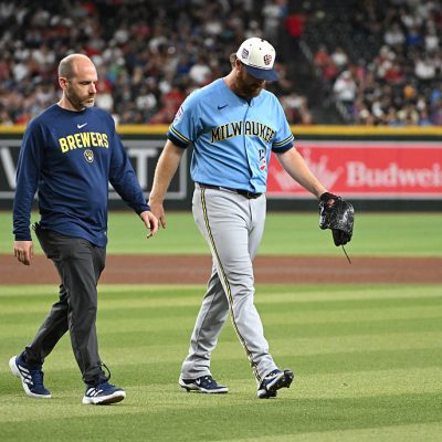 PHOENIX, ARIZONA - JULY 04: Brandon Woodruff #53 of the Milwaukee Brewers leaves the field with head athletic trainer Brad Epstein against the Arizona Diamondbacks during the fourth inning at Chase Field on July 04, 2026 in Phoenix, Arizona. (Photo by Norm Hall/Getty Images)