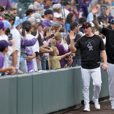 DENVER, COLORADO - SEPTEMBER 24: Members of the Colorado Rockies circle the field after their final home game against the Arizona Diamondbacks at Coors Field on September 24, 2026 in Denver, Colorado. (Photo by Matthew Stockman/Getty Images)