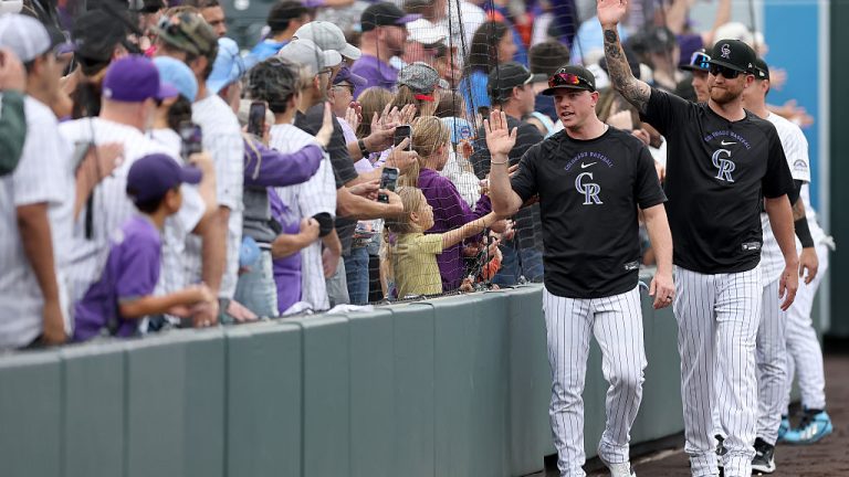 DENVER, COLORADO - SEPTEMBER 24: Members of the Colorado Rockies circle the field after their final home game against the Arizona Diamondbacks at Coors Field on September 24, 2026 in Denver, Colorado. (Photo by Matthew Stockman/Getty Images)