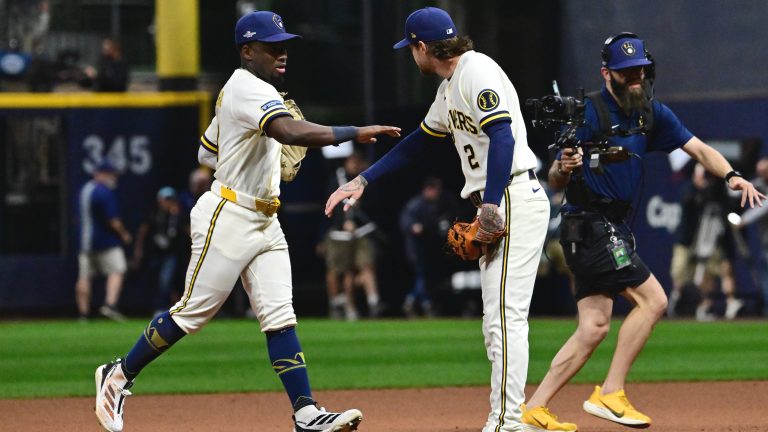Oct 11, 2026; Milwaukee, Wisconsin, USA; Milwaukee Brewers outfielder Luis Lara (18) and second baseman Brice Turang (2) celebrate after defeating the Los Angeles Dodgers in game one of the NLCS for the 2026 MLB Playoffs at American Family Field. Mandatory Credit: Benny Sieu-Imagn Images