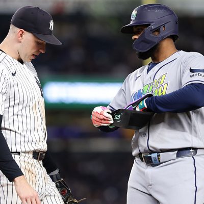 NEW YORK, NEW YORK - SEPTEMBER 24: Junior Caminero #13 of the Tampa Bay Rays speaks with Ben Rice #22 of the New York Yankees on first base during the third inning of the game at Yankee Stadium on September 24, 2026 in New York City. (Photo by Dustin Satloff/Getty Images)